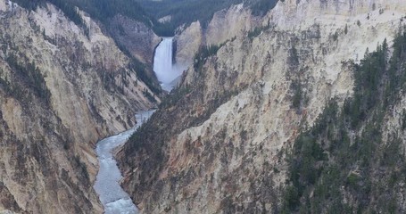 Yellowstone Lower Falls river grand canyon. Upper and Lower falls. National Park in Wyoming geothermal ecosystem environment. Biology, geography and ecology. Millions of tourist and visitors.