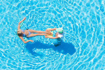 Top view of a man and woman in an outdoor pool.