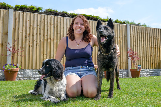 Young woman with dogs in the summer sunshine. 