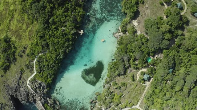 Rising drone shot, top view, above Weekuri Lake, Sumba, in front of the ocean