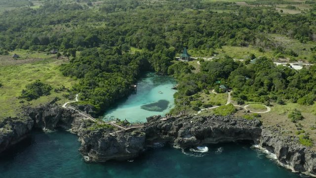Forward drone shot above Weekuri Lake, Sumba, in front of the ocean