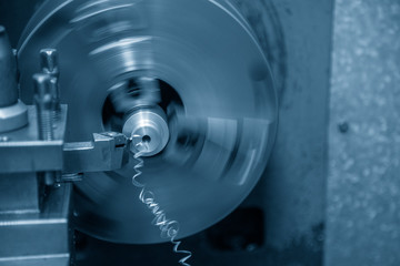Close-up scene of the lathe machine operation while  cutting the metal parts with the cutting tools. The metal working processing by turning machine .