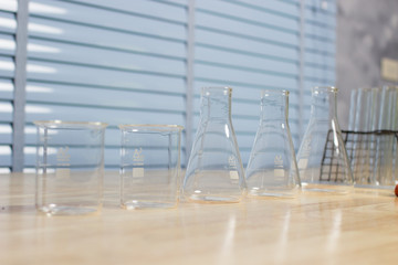 Scientific equipment prepared for the experiment to develop a chemical thread on a wooden table.