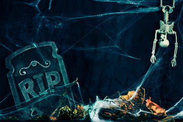 Halloween background,Skeleton Bones, gloomy and dark atmosphere, stretched web in the background