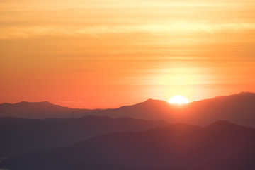 Dramatic sunset and sunrise over mountain morning twilight evening sky.