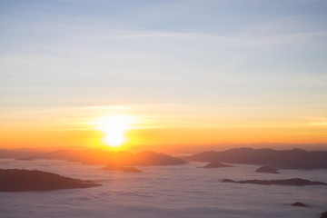 Fototapeta na wymiar Dramatic sunset and sunrise over sea fog mountain morning twilight evening sky.