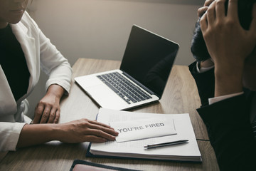 Female manager handed out a sack to the male employee while being stressed at the office.