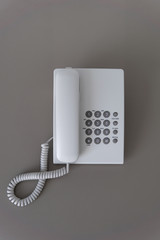 Closeup white phone , office phone on the desk.