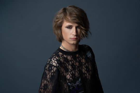 Androgynous beautiful young man on dark background. Model tests.