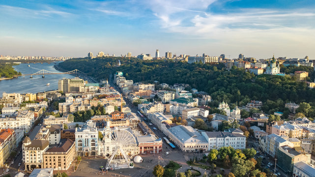 Aerial top view of Kyiv cityscape, Dnieper river and Podol historical district skyline from above, Kontraktova square with ferris wheel, city of Kiev, Ukraine