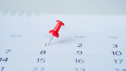 Red pin marking on calendar.