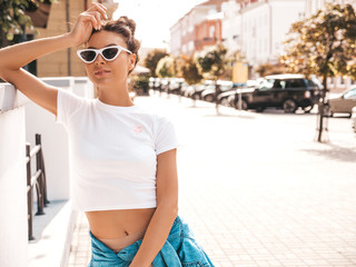 Beautiful smiling model with horns hairstyle dressed in summer hipster jacket jeans clothes.Sexy...