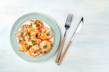 Fried shrimps, overhead shot on a rustic wooden background with a place for text