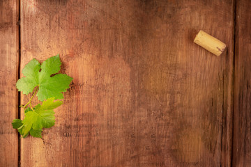A design template for a wine menu or tasting invitation. A vine leaf and a wine cork, shot from...