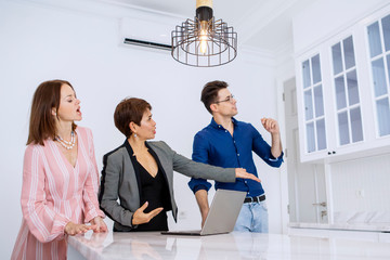 Realtor shows modern kitchen interior to customers