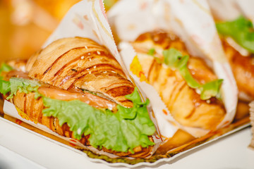 Sandwich croissants with green salad and jamon meat, european breakfast. Catering concept