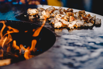 Pork ribs and steak cooked on grill, open fire street food festival