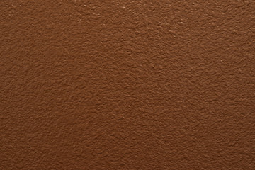 Fototapeta premium Color swatch of brown paint on a section of drywall with light textures.