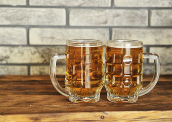 Two glasses of light beer on wooden table. Oktoberfest concept.