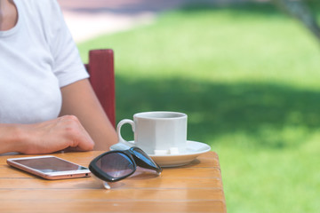  girl drinks coffee outdoors in a cafe