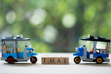 Three wheel taxi name Tuk Tuk racing in Thailand with