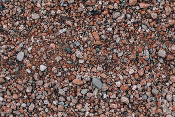 Background of small stones. Stones on the beach, pebbles. Beautiful texture with stones on the nature