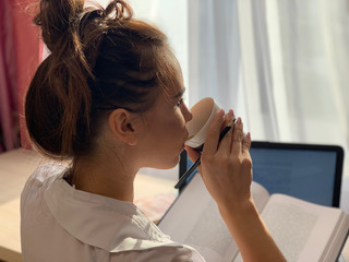 Fototapeta premium Girl drinks coffee in the office.