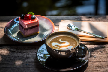 Breakfast with coffee and blueberry cheesecake on the garden terrace