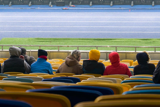 Student Fans And Little Boy Booing Sport Game At Stadium, Watching Junior Match