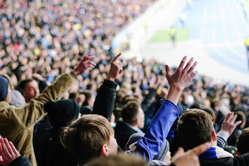 Football fans clapping on the podium of the stadium