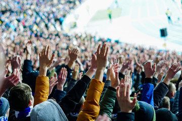 Football fans clapping on the podium of the stadium