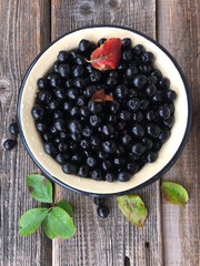 Fresh chokeberry on a wooden table view