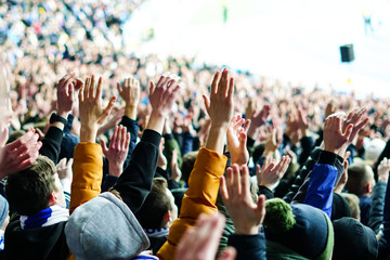 Football fans clapping on the podium of the stadium