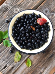 Fresh chokeberry on a wooden table view