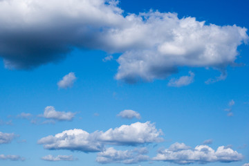 Naklejka na ściany i meble Light cloud in the bright blue sky on a sunny summer day