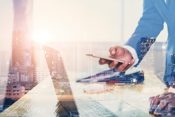 Fototapeta premium Double exposure of business man holding smartphone Searching for information and city night background.technology for business concept.