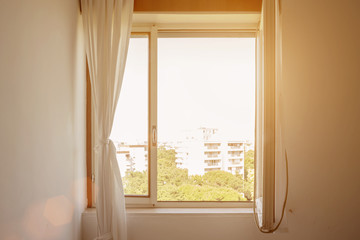 bright sunlight through open wide window penetrates bedroom, ventilating room with fresh air without using air conditioner, taking care of health