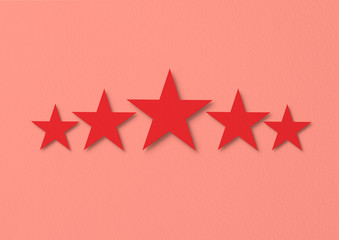 Red stars rating on a pink background, concept of success and achievement of a high level.