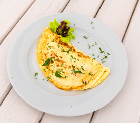 An Omelet with lettuce and a herbs