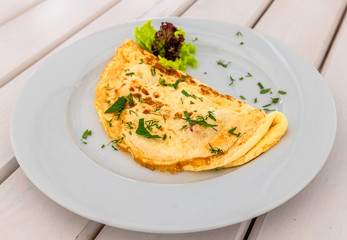An Omelet with lettuce and a herbs