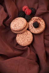 tasty and chocolate macaroni Macaroons and blackberries and raspberries on the table