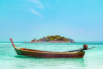 Traditional Thai wooden boat moored in a lagoon