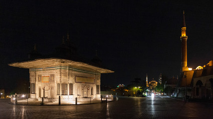 Fototapeta na wymiar Sultan Ahmet III Fountain - Mosques in the background, Instanbul, Turkey