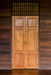 Brown wooden door in wooden house