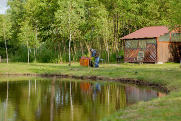 Fisherman catches of salmon fly fishing in the lake.