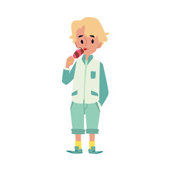Cute little kid, caucasian blond boy stands and eats ice cream.