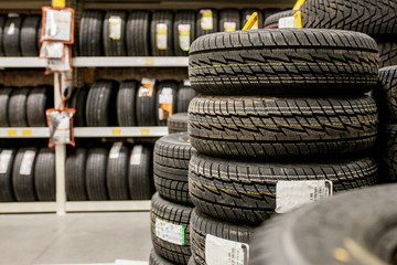 Car tires and wheels at warehouse in tire store.