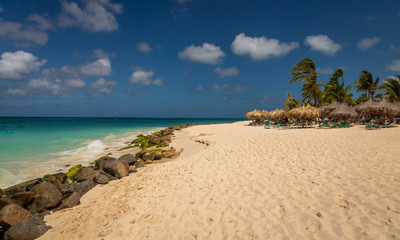Water front, Palm Trees and Chairs in Aruba Eagle Beach. Taken in 2017, this photo was taken in the beautiful Eagle Beach, Aruba, taking advantage of the great conditions at the time.