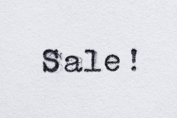 Sale word on white paper printed with typewriter