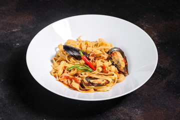 Homemade pasta with mussels, sprinkle with chopped parsley and basil. Delicious of pasta with mussel